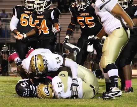 Marquis Lyles (54) and Tim Ballenger make a Yellow Jackets sandwich as they smother this Southside runner on this place.