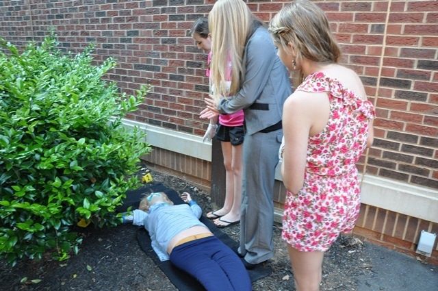 A body at a crime scene is being processed by students of CSI: Day Camp. Students learned how to process and collect crime scene items and data.