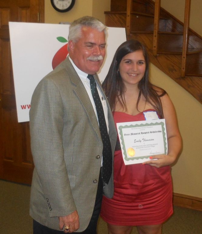 Emily Thomason, a graduate of Greer Middle College Charter High School, received a grant for continuing studies in radiology at Greenville Technical College. John Mansure, President at Greer Memorial Hospital, presented the award.