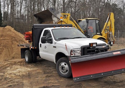 A plow is affixed to a city of Greer truck and sand is being loaded as city crews prepare to battle a winter storm expected to dump up to six inches of snow in the area on Tuesday and Wednesday.
 