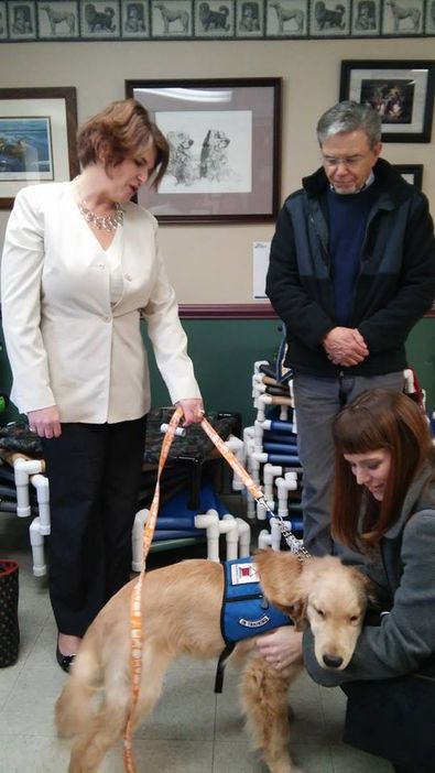 Bill Brightman from Service Dogs for Veterans, Melissa Yetter from Service Dog Institute introduce Greer Leadership member Bethany Hembree to a service dog in training