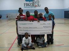 Children from the Frazee Dream Center display the $9,000 check they received from the Sugar Creek Fun Runs.
