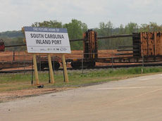 Rail cars are lined up at the Inland Port in Greer with rails to be used for new tracks to accommodate a separate spur into the port and 4 sections of track on each side of the facility for storage.