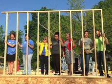 Homeowner Yadira Neriz (center, gray shirt) and community partners participated in the ceremonial wall raising for her new home.
 
 