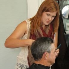Staff Sgt. Henry Campbell gets his hair trimmed by Samantha Ball at The White House Salon Monday. Campbell was in Korea, Viet Nam, Iceland and Germany among the six countries he was stationed.
 