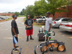Members of the drum line gather to take their instruments onto the practice field during an afternoon workout. Rashad Moore plays the snare drum, Malik Keenan the bass drum and Demantio Rosemond tenor drum.
 