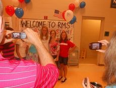 Principal Eric Williams, left, and a school official, were an assembly line getting all the pictures taken. 