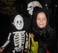 Gavin Ludwigsen, representing a skeleton, and his brother, Dylan, the Grim Reaper were trick-or-treating on Trade Street Tuesday night. 