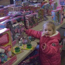 Tables filled with a variety of toys, dolls and books awaited children as they shopped uninhibited. Parents waited at an exit.