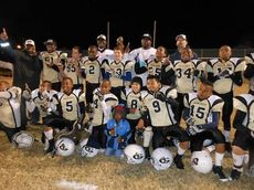 The Yellow Jackets celebrate the 12-under championship they won tonight at Greer City Stadium.