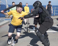 James Wright, a Greenville native, fights off a simulated attacker aboard the guided-missile cruiser USS Philippine Sea. 
 