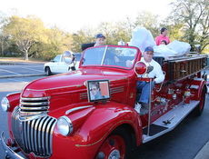 Gerald Davis, behind the wheel, drove the 1941 Chevy Southern Pumper Fire Truck, to pick up toys from the Syl Syl Toy Drive at the Clock restaurant.
 