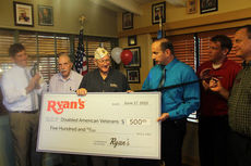 Greg Beehner, blue shirt, vice president of operations for Ovation Brands, presents Preston Johnson of the Disabled American Veterans a $500 check at Ryan's . Attending the presentation and ribbon cutting are Mark Owens, left, president/CEO of the Greater Greer Chamber of Commerce, veteran Jimmie Jordan, district marketing manager Ryan Knoblauch, red shirt, and Jeff Engst, Ryan's general manager.
 
 