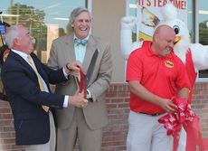 It was anything but an ordinary ribbon cutting at Bojangles' at Buncombe today. City Administrator Ed Driggers and Mayor Rick Danner (bow tie) laugh after it took about a dozen tries to cut the traditional red Bojangles' ribbon. District Manager Dempsey  Roberts gathers up the bow.
 
