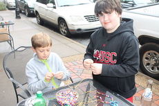 Jackson Suber, left, and Brady Brown have set up JB's Arts & Crafts, a holiday enterprise, outside the Stomping Grounds at 208 Trade Street.
 
 