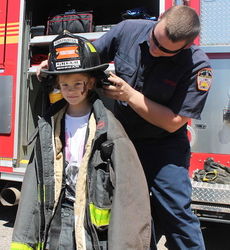 On the home page, is a junior firefighter in full gear.
 