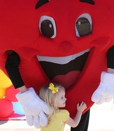 Heart to heart. A little girls is drawn to the Heart Association's mascot at the Heart Walk at Greer City Park Saturday.