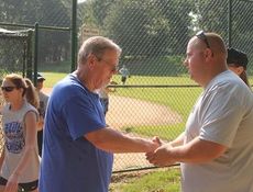 Roger Rice, Sr., father of Laurens County Deputy Roger Rice, Jr., killed in action in 2011, is greeted at the weekend softball tournament at Greer's Century B Park.
 