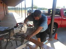 Tom Center, who donated the wood panels and equipment, cuts the wood into exact sizes so it fits like a puzzle.