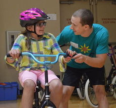 Will Cannon is rewarded with a broad smile from Mary Ruth Eielders at the iCan Bike Camp at the Taylors Recreational Center.
 
