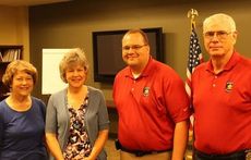 Marsha Lee and Karen Moose are partnering with the Greer Police Department, Sgt. Chad Richardson and Chief Dan Reynolds, left, with their Book Bag Project. The sisters will fill the bags and Greer police will identify and provide the bags to the homeless.