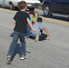 Children scrambled into the street during the Greer High School Homecoming Parade to collect candy thrown by the parade's participants. City Council is scheduled to give second and final reading to adopt the banning of 
