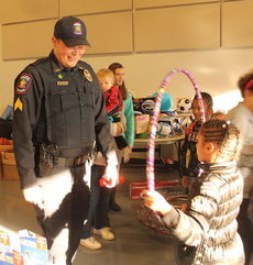 Police officers enjoyed seeing children playing with their toys.
 