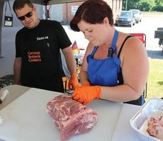 Brianca Kruse cuts the fat off the meat to prepare it for the cooker. Sascha, her husband, and Brianca are competing as the German Redneck Cookers for the first time in Greer.
 
 