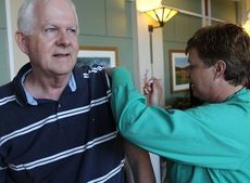 Bill Edwards from Taylors is given his flu shot from nurse Deidre Nall.
 