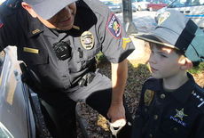 Corporal Joe Phillips gave Gunner, 4, a hands-on tour of the Greer Police Department and a patrol car Wednesday.
 