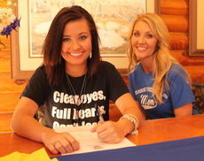 Kelsi Davis signs with Spartanburg Methodist College to play soccer in the fall. Her mother, Brandi Sims, is at her side.
 