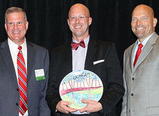 Jason Clark, center, owner of BIN112 received one of the biggest ovations as recipient of the Restaurateur of the Year in the Upstate. Stan Coster, Vice President of Ballentine Equipment, right, nominated Clark.
 
 