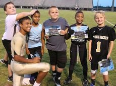 Adrian McGee proved popular with some Upstate Jackets Football players at Meet the Jackets night Thursday at Dooley Field. The Greer Parks and Recreation Department provided all its youth football players a team photo of the Greer Yellow Jackets for autographs.