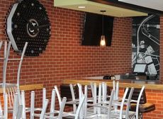 R.J. Rockers Flight Room exhibits its personality with a handmade signature wall clock made from bottles, the polished wood counter is from a Spartanburg mill, and the mural is an aerial view of the airport stretched across the interior.
 
 