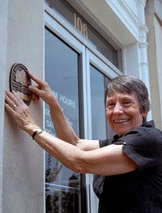 Joada Hiatt showcases the National Register plaque awarded to the Greer Heritage Museum as a National Landmark located in the old Greer Post Office at 106 Main Street.
