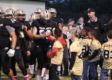 Youth football players sought Greer varsity players' autographs Friday night at Dooley Field. Greer Recreation youth players and cheerleaders were recognized at halfitme.