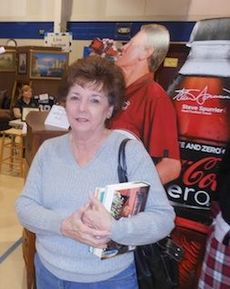 Barbara Edwards found several volumes of books she purchased this afternoon at Big Thursday. A cutout of USC Head Football Coach Steve Spurrier, will be in the live auction later this evening, obviously competing against its cardboard rival Dabo Swinney of Clemson. 