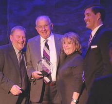 Bernard Price received the Senator J. Verne Smith Award as he is flanked by sponsors Keith and Donna Smith. Chamber President/CEO Mark Owens is on the right.
 
 
 