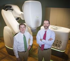 Doctors Jeremy Kilburn, left, and Dan Fried of the Gibbs Cancer Center with the CyberKnife.
 