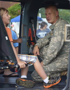National Guard reserves chatted with children who were fascinated with the inside of this chopper and the military equipment and displays at City Park.
 