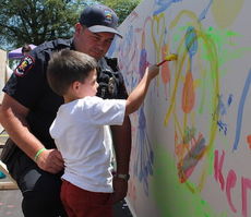 Hayden Keller, son of Greer Police officer Wes Keller, puts the finishing touches on the Creation Station graffiti wall.
 
