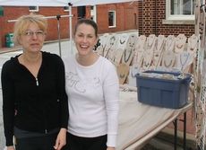 Iolanda Smith, left, and Laura D'Amato were setting up their Ioli Hancrafted Jewelry display on Trade Street this afternoon to prepare for the expected crowds in downtown Greer this weekend.