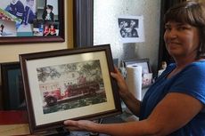 Julie Linderman shows a picture of a 1941 Chevy Southern pumper truck purchased new by the city.  Allen Cullun, grandson of B.A. Bennett, who later bought the truck, gave it back to the city to be refurbished for the fire department’s 100th anniversary in 2014.