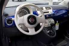 The Fiat 500 has 14 exterior colors and an ivory or black interior choice. The dash incorporates the exterior color throughout.