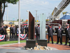 Fire Department personnel surround the World Trade Center Memorial Plaza where a steel I-beam was anchored to honor all first responders and civilians killed in New York City on Sept. 9, 2011.