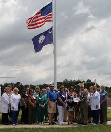 Staff at Greer Memorial Hospital join in the celebration commemorating Capt. Ashley Blessums presenting the United States flag that flew over her base in Afghanistan.