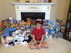 Timmy Dunlap sits among the donations from audience members of a variety show he organized and presented at North Greenville University. The donations benefitted the boys at the Avalonia Group Homes and Excalibur Youth Services.
 
 