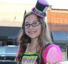 Girls were in character with matching costumes and hats as they honored merchants on Trade Street with their presence.