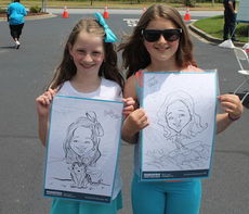 These two girls show off their caricatures.
 
 