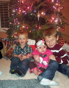 Mason (2), Brooke Lathrop's niece Gabby (6 months), and stepson Brayden (8) on Christmas Day 2013.
 